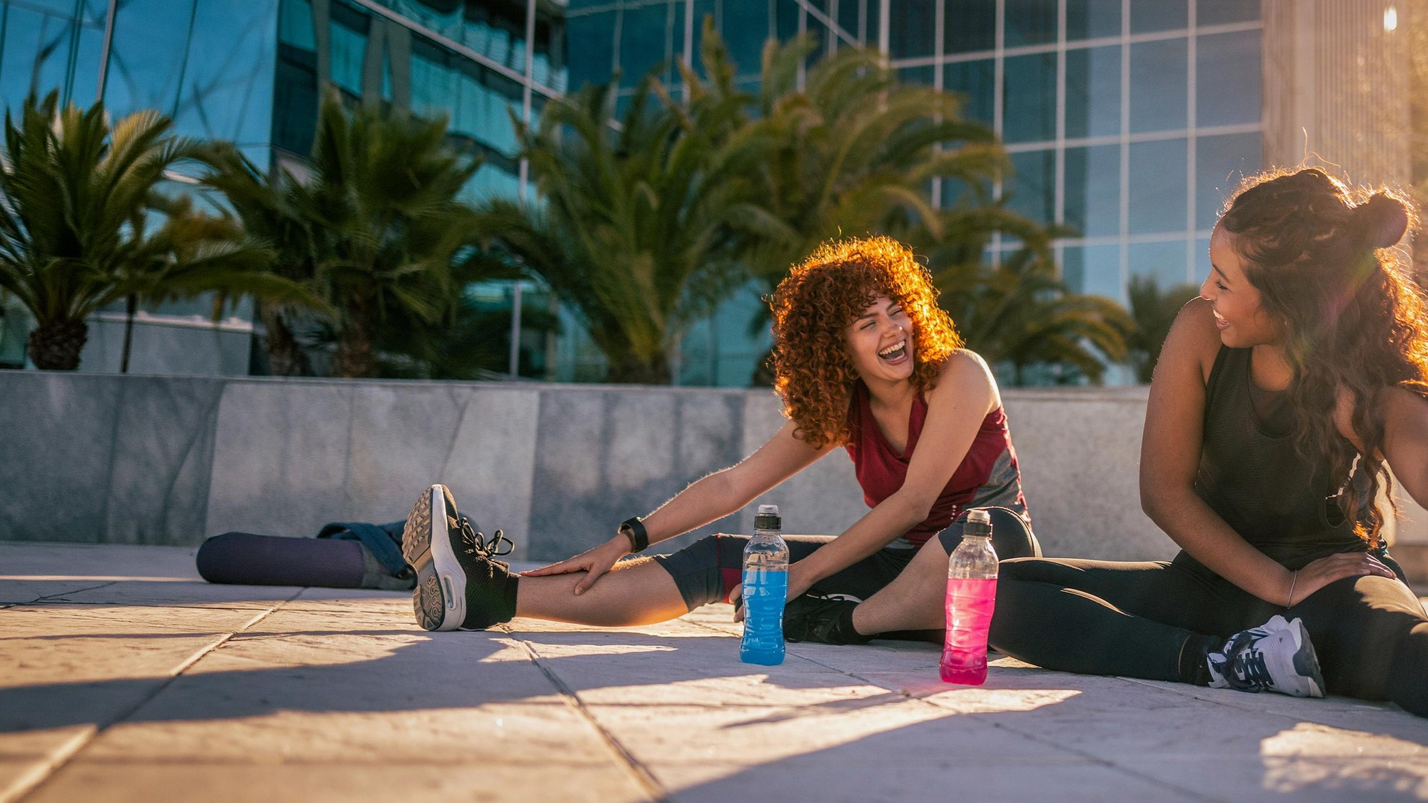 women-smiling-stretching-outside-hero-16-9-2560x1440px