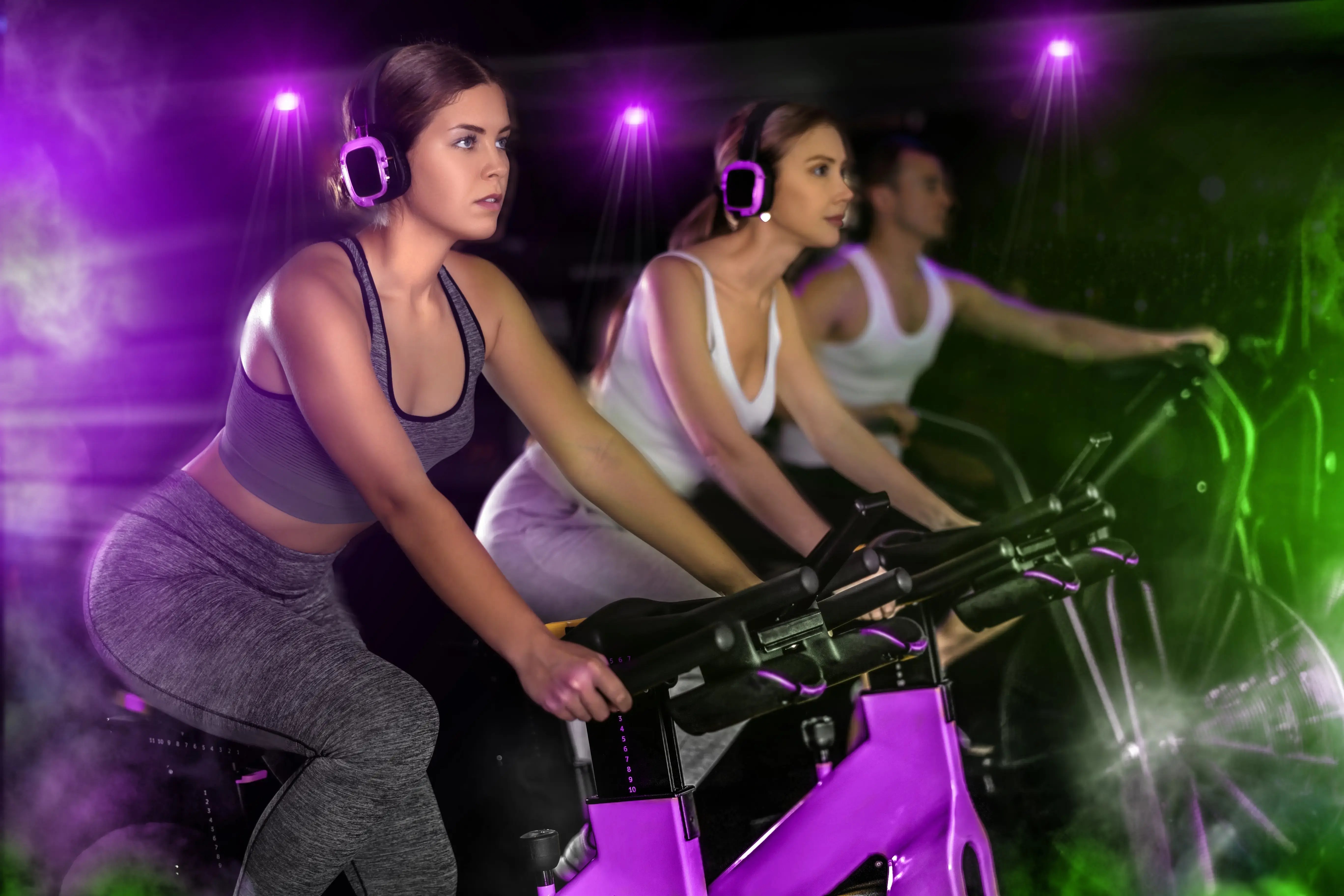 A group of people exercising on spin bikes.