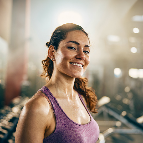 woman-smiling-gym-closeup-1-1-544x544px