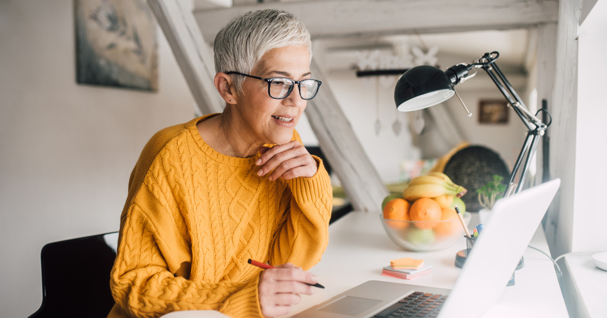 Ageing employee working at laptop