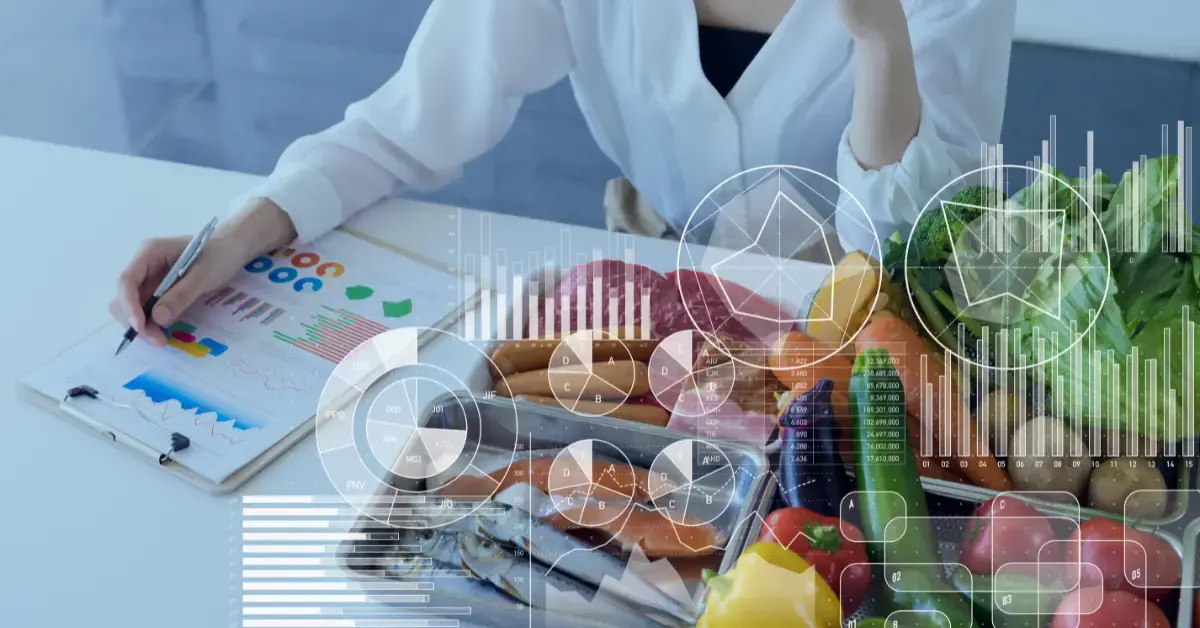 A person writes on a clipboard with charts next to a table of fresh foods, including vegetables, fruits, fish, and meat—illustrating Why Nutrition Matters for employee Energy and Performance—overlaid with digital data graphics and charts.